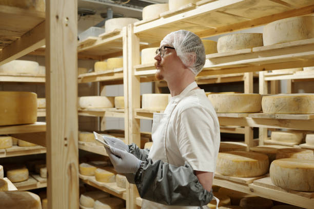 istock Inspecting Cheese Wheels in a Storage Room 2195952682