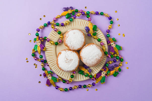 Mardi gras carnival polish donuts, beads and throws on purple background