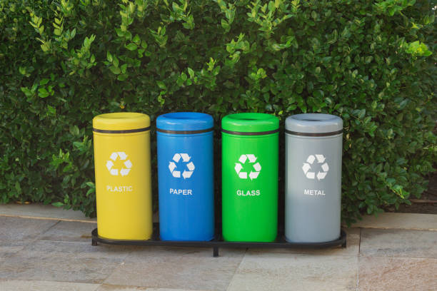 istock Colorful trash bins for waste segregation. (plastic, paper, metal, glass). Separate waste collection. Sorting garbage by material and type. 2195952884