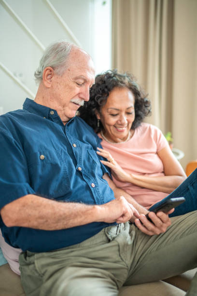 istock Senior Couple Engages with Technology at Home 2195952981