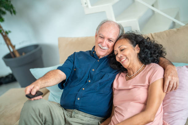 istock Senior Couple Enjoys Television Time Together 2195952982