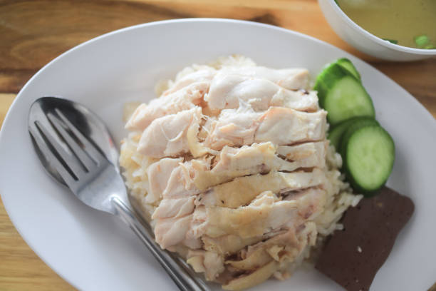 istock Chicken rice in a white plate with cucumber and soup in a cup, Thai called Khao Man Kai, a famous Thai Food. 2195964416