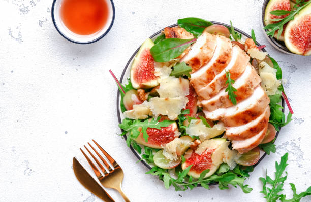 istock Delicious lunch with chicken, figs, cheese, grape and herbs. White background, top view 2195965642