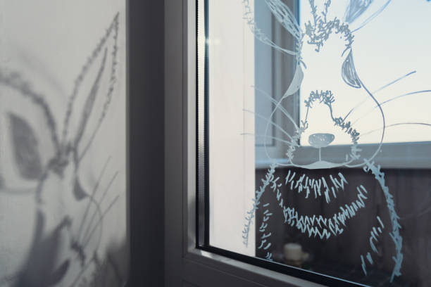 istock Zero cost responsible holiday decor economically driven. Painted Easter bunny rabbit on window glass indoor at home. Affordable alternative Easter springtime seasonal tradition ideas decoration 2195967969