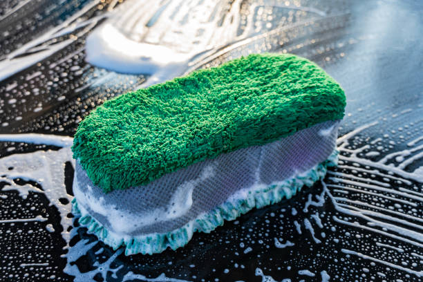 Concept of washing the car with a microfiber sponge