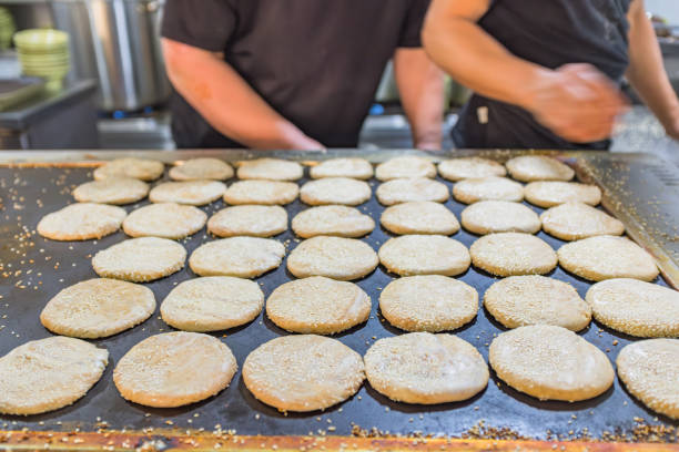 Stock photo showing close-up, elevated view of a pile of tiny sesame seeds, also known as benne. Sesame seeds are often sprinkled onto the top of burger buns for an added crunch, while they are also used as an ingredient in Asian cuisine and frequently ground to produce a very distinctive oil.