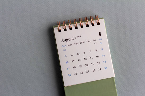 istock A desktop calendar for August 2025 and a writing pen on a gray background. 2195972492