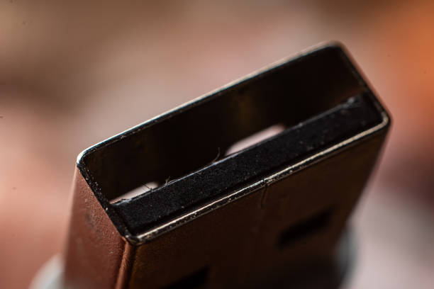 This close-up captures the intricate details of a USB connector against a soft backdrop. The focus highlights texture and color variations, offering a modern aesthetic.