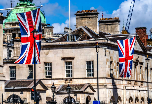 Goverment Buildings Including Horse Guards British Flags Whitehall London England.  Horse Guards is a historic building, which houses the King's Household Cavalry.