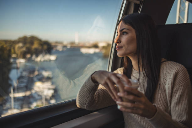 istock Female tourist on a train looking out the window 2195976026