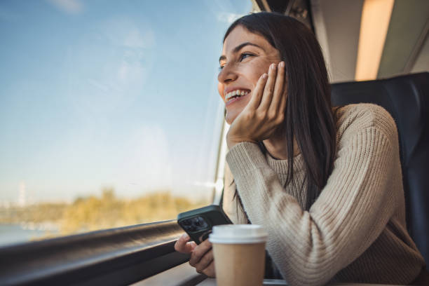 istock Female tourist on a train looking out the window 2195976047