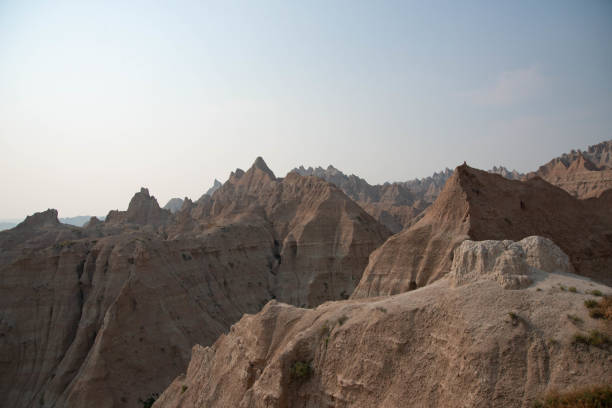 The rugged beauty of the Badlands draws visitors from around the world. These striking geologic deposits contain one of the world’s richest fossil beds. Ancient horses and rhinos once roamed here. The park’s 244,000 acres protect an expanse of mixed-grass prairie where bison, bighorn sheep, prairie dogs, and black-footed ferrets live today.