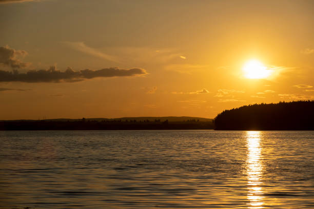 istock orange sky during sunset on the lake 2195979565