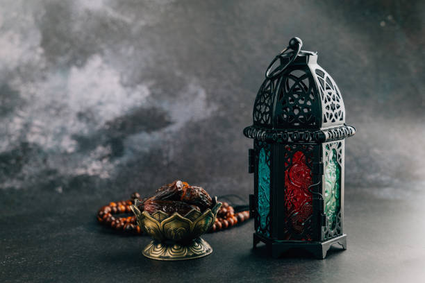 Decorative Ramadan scene with dates, prayer beads, and lantern, ideal for a meaningful Ramadan ambiance on dark background