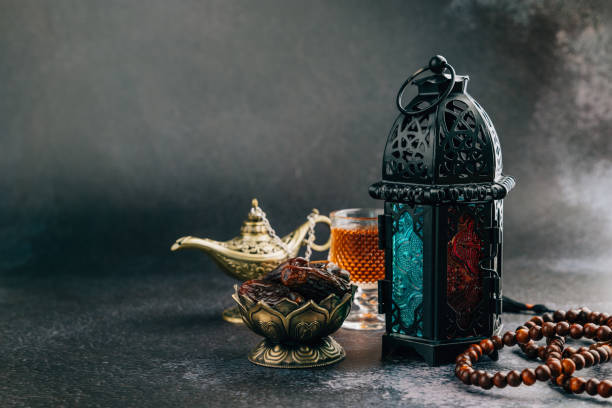 istock Holy Ramadan theme featuring dates, decorative lantern, beads, and vintage lamp on dark background for a serene decor 2195982350