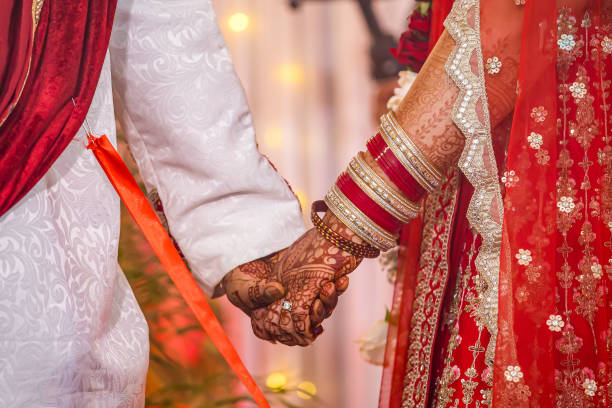 istock Indian couple's holding hands close up 2195983883