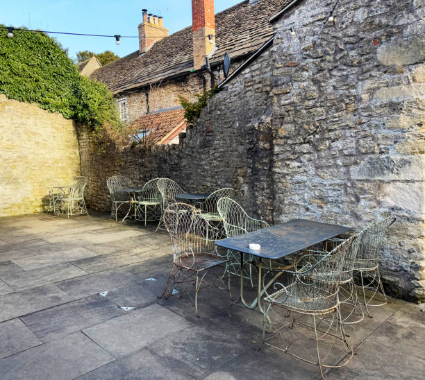 istock Old metal tables and chairs in a courtyard 2195984991