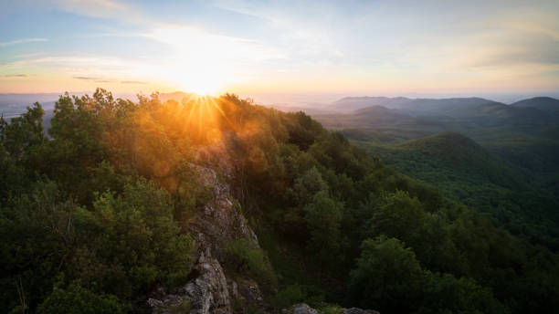 istock Sun rising over beautiful hilly landscape with rocks, deciduous forest and trees, Slovakia, Europe 2195986271