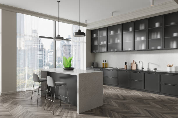 istock Modern kitchen interior with sleek cabinets, island, and city view through large windows. 3D Rendering 2195986497