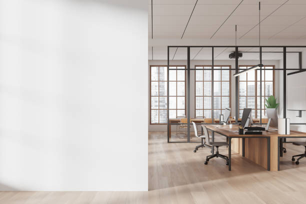 istock Blank wall and modern office interior with wooden desks, chairs, and large windows in open space loft concept. 3D Rendering 2195986630