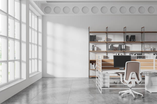 istock Modern office interior with an open space design, featuring shelves, desk, and large windows on a sunny day. 3D Rendering 2195986900