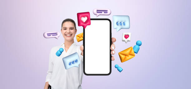 istock Smiling woman holding a smartphone with a blank screen surrounde 2195987742