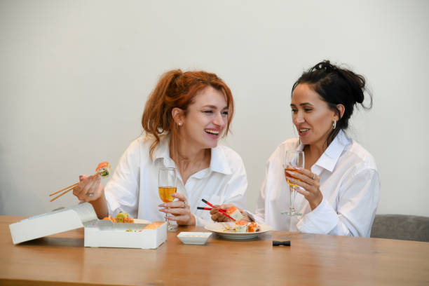 istock Friends enjoying sushi and drinks together at a cozy setting during a social gathering 2195988249