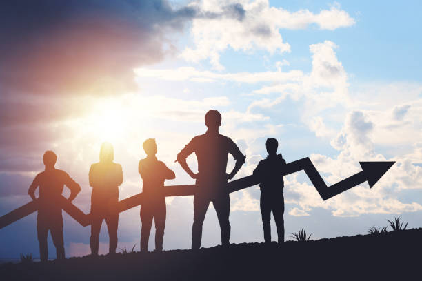 istock Team silhouette and up graph arrow on sunset background, leadership and teamwork concept 2195988260