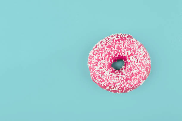 istock Pink donut on color background, flat lay, top view 2195988515