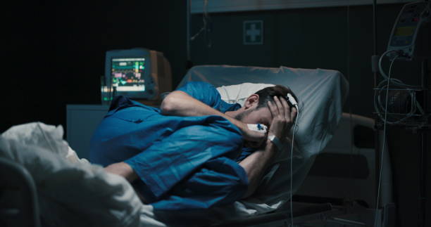 istock A young patient in a hospital ward lying on a bed suffering from abdominal pain 2195991432