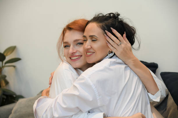istock Two women share a warm hug in a cozy setting, celebrating their friendship and connection 2195991471