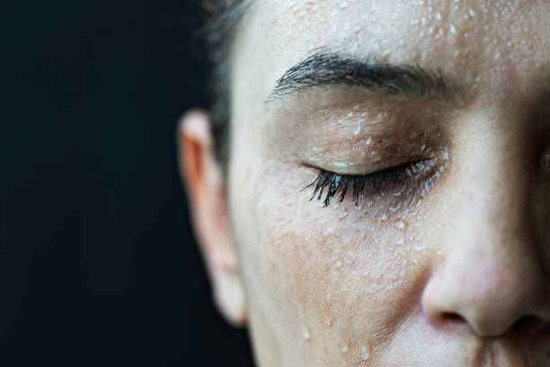 istock Close-Up of Woman's Face with Water Droplets 2195992688