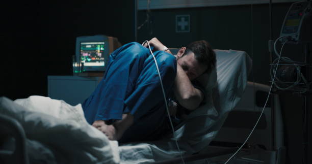 istock A young patient in a hospital ward lying on a bed suffering from abdominal pain 2195992702