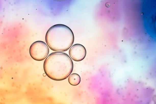 istock Abstract Oil Droplets Floating on Colorful Gradient Background 2195994684