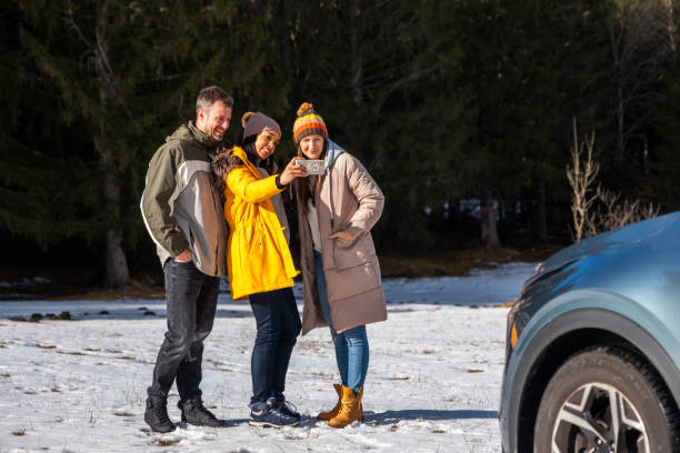 istock Friends Enjoying Smartphone Outdoors in Winter 2195995855