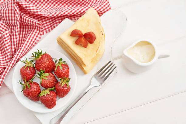 Delicious strawberry crepe on the brown wood table