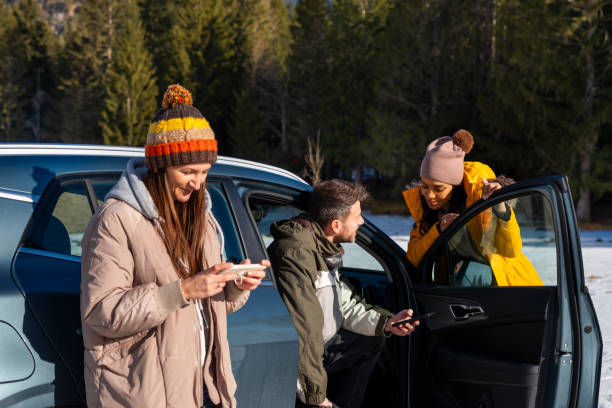 istock Friends Enjoying Smartphone Outdoors in Winter 2195996010