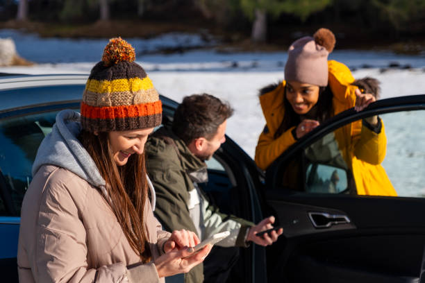 istock Friends Enjoying Smartphone Outdoors in Winter 2195996045