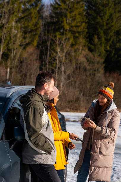 istock Friends Enjoying Smartphone Outdoors in Winter 2195996046