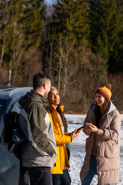 istock Friends Enjoying Smartphone Outdoors in Winter 2195996049