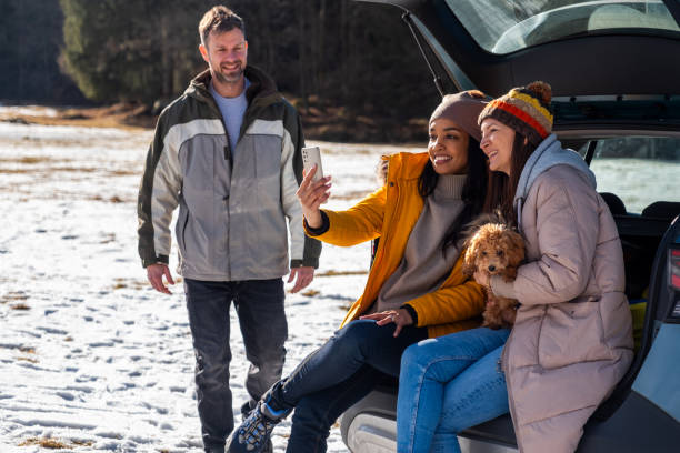 istock Friends Enjoying Smartphone Outdoors in Winter 2195996065