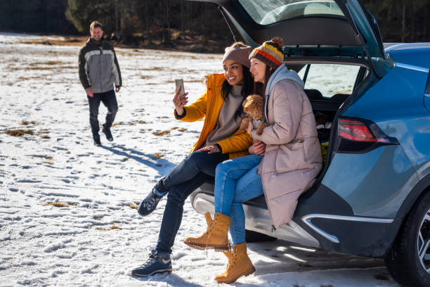 istock Friends Enjoying Smartphone Outdoors in Winter 2195996068