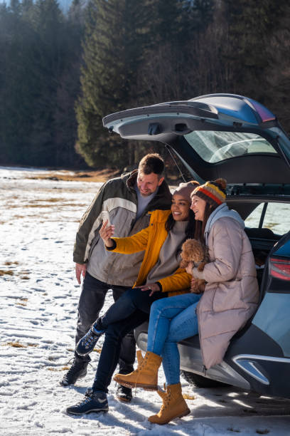 istock Friends Enjoying Smartphone Outdoors in Winter 2195996073