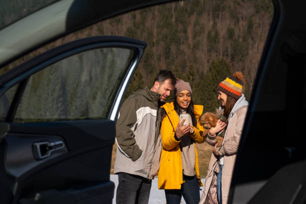 istock Friends Enjoying Smartphone Outdoors in Winter 2195996095