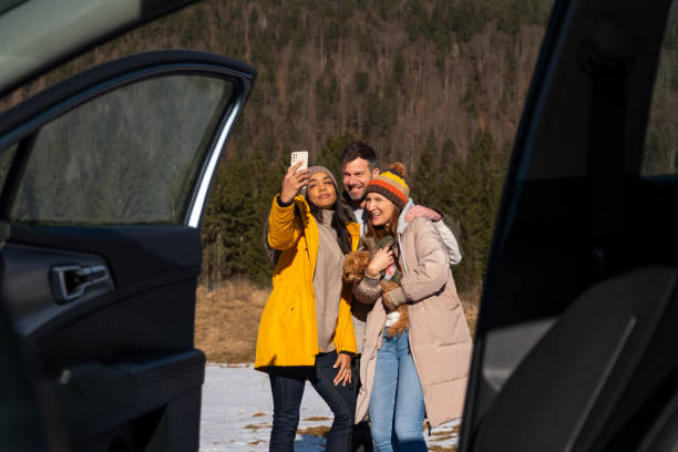 istock Friends Enjoying Smartphone Outdoors in Winter 2195996114