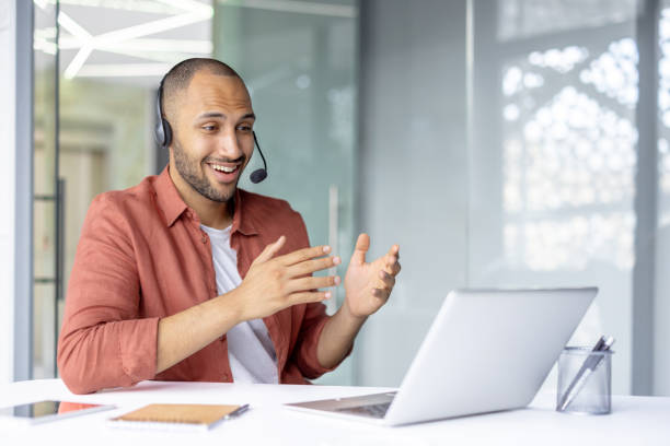 Businessman communicating online with a headset in a professional setting