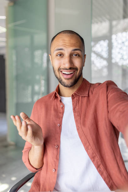 istock Confident adult man smiling while gesturing during an online discussion 2196000138