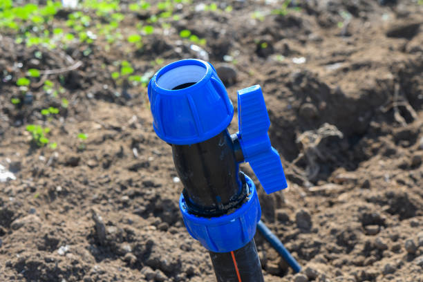 istock Sprinkler system ready for use in a vibrant green garden on a sunny afternoon 2196001797