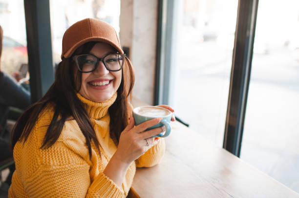 istock Young woman drinking coffee in cafe 2196002294