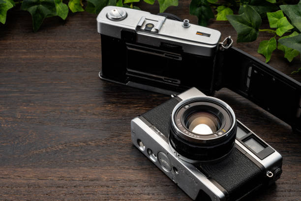 Old film camera on wooden table